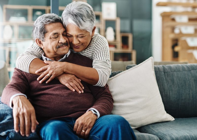 A happy elderly couple hugging each other